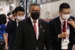 World Health Organization Director-General Tedros Adhanom Ghebreyesus, center, arrives for the opening ceremony of the Tokyo 2020 Olympic Games, at the Olympic Stadium in Tokyo, on July 23, 2021.