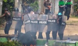 This screengrab provided via AFPTV and taken from a broadcast by Myitkyina News Journal on March 27, 2021 shows security forces crack down protesters during a demonstration against the military coup in Myitkyina in Myanmar's Kachin state.