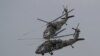 FILE - Two U.S. Black Hawk helicopters participate in a media demonstration.