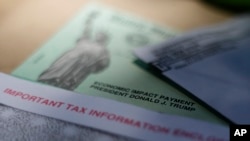 FILE - This April 23, 2020, file photo shows President Donald J. Trump's name printed on a stimulus check issued by the IRS to help combat the adverse economic effects of the new coronavirus outbreak in San Antonio. The Mexican American Legal…