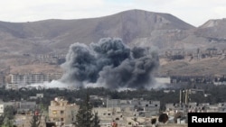 Smoke rises from an explosion in besieged Eastern Ghouta in Damascus, Syria, Feb. 27, 2018. 