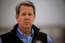 FILE - Georgia Gov. Brian Kemp listens to a reporter's question at the Georgia World Congress Center on April 16, 2020, in Atlanta.