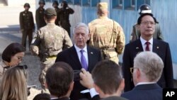 U.S. Defense Secretary Jim Mattis, center, speaks to the media as South Korean Defense Minister Song Young-moo, right, looks on during a visit to the truce village of Panmunjom in the Demilitarized Zone (DMZ), Oct. 27, 2017.