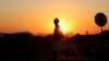 FILE - A miner returns from his shift in Nkaneng township outside the Lonmin mine in Rustenburg, northwest of Johannesburg, June 26, 2015. 