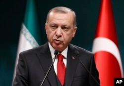 Turkey's President Recep Tayyip Erdogan talks during a news conference at the Presidential Palace in Ankara, Dec. 20, 2018.