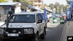 United Nations (UN) observers traveling in UN vehicles leave the UN office in Damascus, April 26, 2012