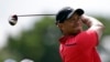 FILE - Tiger Woods hits from the third tee during the final round of the Cadillac Championship golf tournament.