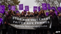 French actress Muriel Robin, center, marches with participants holding a banner that reads "Stop violence towards women" as they take part in a rally in Paris, Nov. 24, 2018. 