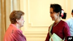 Myanmar's leader Aung San Suu Kyi, right, shakes hands with Philippine diplomat Rosario Manalo, a member of the Independent Commission of Enquiry for Rakhine State, at the Presidential Palace in Naypyitaw, Myanmar, Monday, Jan. 20, 2020. An…