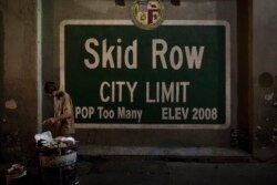 Seorang pria tunawisma mengambil makanan dari tempat sampah di daerah Skid Row Los Angeles, kota tunawisma terbesar di negara itu, 28 Oktober 2017. (Foto: AP)