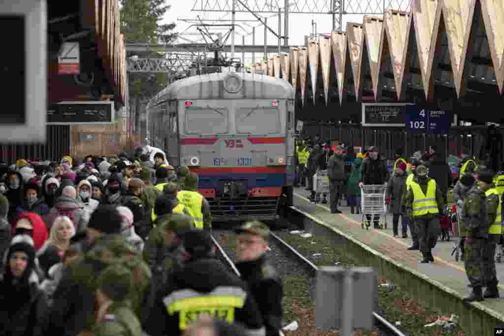 Refugees from Ukraine arrive to the railway station in Przemysl, Poland, Feb. 27, 2022.