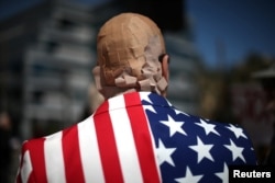 Mike Stutz is seen with his head covered in band aids to protest against President Trump's proposed replacement for Obamacare in Los Angeles, California, March 14, 2017.