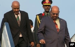 FILE - Sudan President Omar al-Bashir, right, arrives in Kigali, Rwanda, July 16, 2016, to attend an African Union summit. He defied an international warrant of arrest after public assurances from Rwandan leaders that he would not be arrested.