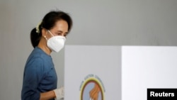 FILE - Myanmar State Counselor Aung San Suu Kyi arrives for an early vote ahead of the general election in Naypyitaw, Myanmar, Oct. 29, 2020. 