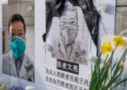 Chinese students and their supporters hold a memorial for Dr. Li Wenliang, who was the whistle-blower of COVID-19, outside the UCLA campus in Westwood, Calif., Feb. 15, 2020.