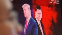 2019年8月26日，一名貨幣交易員在南韓首爾KEB Hana銀行總部的外匯交易室工作時，電腦屏幕上顯示中國國家主席習近平(右)和美國總統唐納德·特朗普(Donald Trump)的圖像。