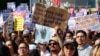 Supporters of the Deferred Action for Childhood Arrivals, or DACA chant slogans and hold signs while joining a Labor Day rally in downtown Los Angeles on Sept. 4, 2017. 