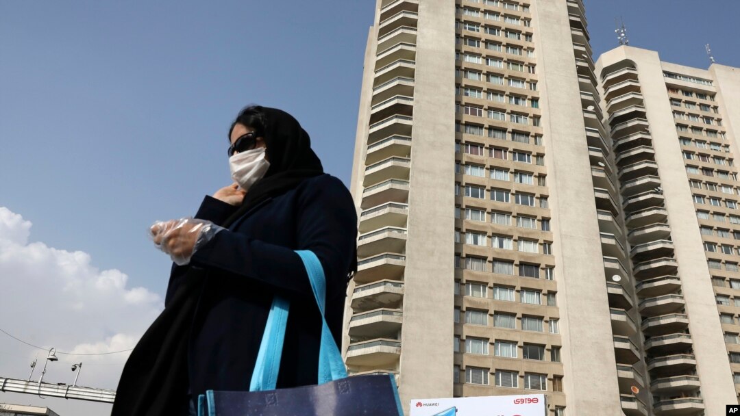 A pedestrian wearing a face mask crosses a street in northern Tehran, Iran, March 1, 2020.