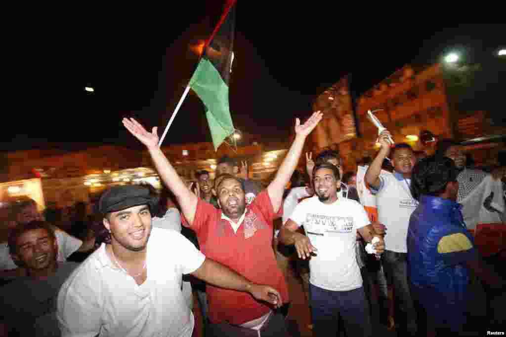 People dance in the streets as they celebrate the national election in Benghazi,Libya, July 7, 2012. 