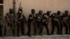 FILE - Soldiers from the 1st Battalion of the Iraqi Special Operations Forces are stacked against a building during a training exercise to prepare for the operation to retake Mosul from Islamic State militants, in Baghdad, Iraq, Aug. 13, 2016. 