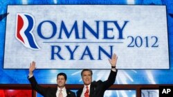 Republican presidential nominee Mitt Romney and vice presidential nominee Paul Ryan wave to delegates after speaking at the Republican National Convention in Tampa, Florida, August 30, 2012. 