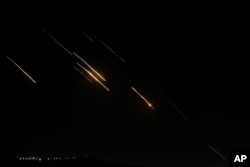 Missiles launched from Iran towards Israel are seen in the West Bank city of Nablus, Oct. 1, 2024.