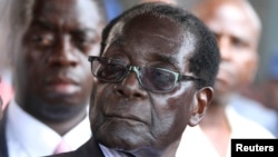 FILE: Zimbabwe President Robert Mugabe addresses supporters outside ZANU-PF headquarters, Harare, Oct. 30, 2014.