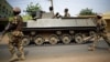 FILE - Nigerian troops patrol in the northeastern Nigeria city of Mubi, 20 kilometers (14 miles) west of the Cameroon border, March 2015.