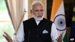 Indian Prime Minister Narendra Modi delivers a joint statement with French President Emmanuel Macron after their meeting at the Elysee Palace in Paris, France, June 3, 2017. 