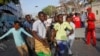 Somalis help a wounded civilian after a car bombing in Mogadishu, Somalia, March 22, 2018. 