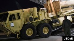In this photo provided by U.S. Forces Korea, trucks carrying U.S. missile launchers and other equipment needed to set up the Terminal High Altitude Area Defense (THAAD) missile defense system arrive at the Osan air base in Pyeongtaek, South Korea, March 6.