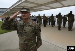 In this file photo taken on June 29, 2018, US soldiers salute during a grand opening ceremony of the new headquarters building for the United Nations Command and US Forces Korea at Camp Humphreys in Pyeongtaek.