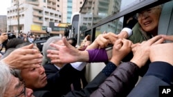 Seorang perempuan Korea Utara yang tidak diketahui identitasnya mengulurkan tangannya untuk menggenggam tangan keluarganya di Korea Selatan ketika berpisah setelah reuni keluarga di Korea Utara, 22 Oktober 2015.