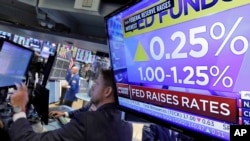 Kenaikan tingkat suku bunga Bank Sentral AS ditunjukkan di layar televisi di lantai bursa New York, 14 Juni 2017.