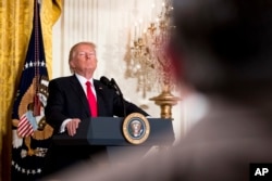 FILE - President Donald Trump takes a question during a news conference, Feb. 16, 2017, in the East Room of the White House in Washington.