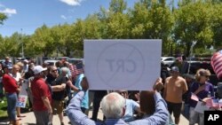 A man holds up a sign against Critical Race Theory during a protest outside a Washoe County School District board meeting in Reno, Nev. (Andy Barron/Reno Gazette-Journal via AP, File) 
