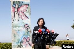 Taiwanese President Tsai Ing-wen standing by a section of the Berlin Wall speaks to media at the Ronald Reagan Presidential Library in Simi Valley, California, Aug.13, 2018.