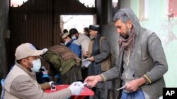 Warga Afghanistan antre untuk menerima pembagian makanan yang diselenggarakan oleh Program Pangan Dunia (WFP) di Pul-e-Alam, ibu kota provinsi Logar, Afghanistan timur musim dingin lalu (foto: dok). 