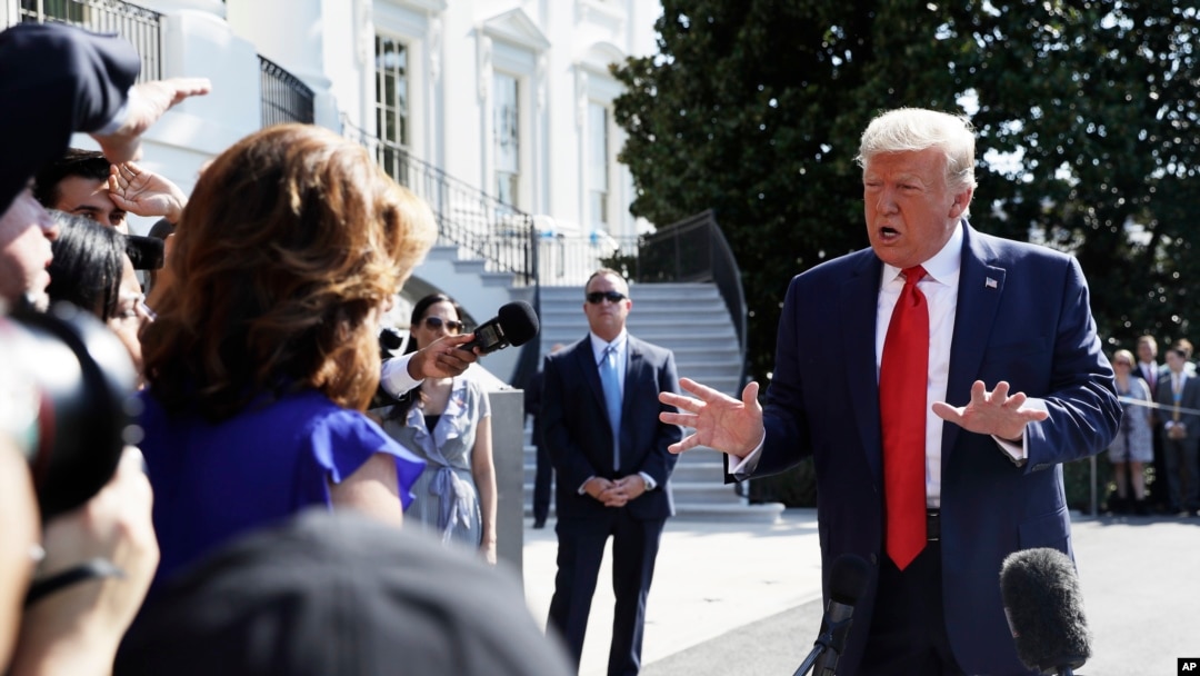 FILE - President Donald Trump talks to reporters on the South Lawn of the White House, Aug. 9, 2019, in Washington.
