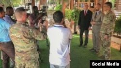 FILE - AFRICOM Commander Gen. Stephen Townsend, right, is seen with other officials during a joint media event in Mogadishu, Somalia, on a photo posted on Twitter by @USAfricaCommand, Nov. 5, 2019.