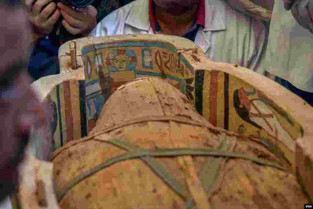 Some of the coffins are fully painted with scenes from the book of the dead and the titles of the deceased, exactly as the scriptures painted on the tomb's murals. (H. Elrasam/VOA)