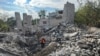 Volunteers search for bodies of people killed during Russia's attack in the town of Izium