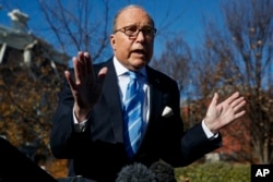 FILE - White House chief economic adviser Larry Kudlow talks with reporters about trade negotiations with China, at the White House, Dec. 3, 2018.