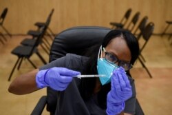 Seorang petugas kesehatan menyiapkan dosis vaksin COVID-19 di Houston. (Foto: Reuters)