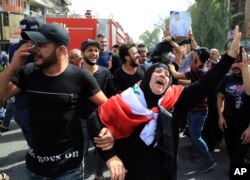 Iraqis grieve during the funeral procession of bomb victim, Akram Hadi, 24, who was killed in a massive truck bomb attack in the Karada neighborhood of Baghdad, Iraq, July 5, 2016.