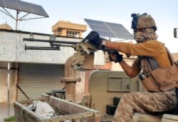 FILE - Afghan Special forces patrol a deserted street during fighting with Taliban fighters, in Lashkar Gah, Helmand province, southern Afghanistan, Aug. 3, 2021.