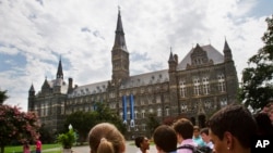 FILE - Prospective students tour Georgetown University's campus July 10, 2013, in Washington.