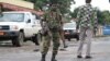 FILE - A Burundian soldier with his gun and rocket launcher guard a deserted street in Bujumbura, Burundi, Nov. 8, 2015. 