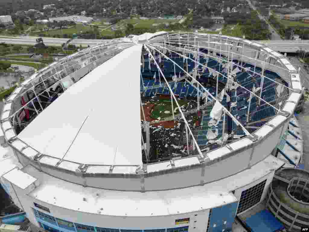 A drone image shows the dome of Tropicana Field which has been torn open due to Hurricane Milton in St. Petersburg, Florida. At least four people were confirmed killed as a result of two tornadoes triggered by Hurricane Milton on the east coast of the state of Florida, local authorities said.