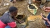 FILE - An artisanal miner washes tin ore before it is bagged up and weighed, ready to be transported to the nearest major town for export in the Kalimbi tin mine near the small town of Nyabibwe, D.R.C.